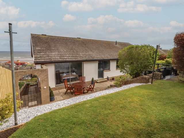 A house with a garden and patio at Tigh-Na-Mara Retreat
