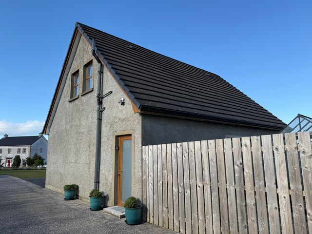 A house with a door and windows at The Loft - 96B Macosquin near Castlerock