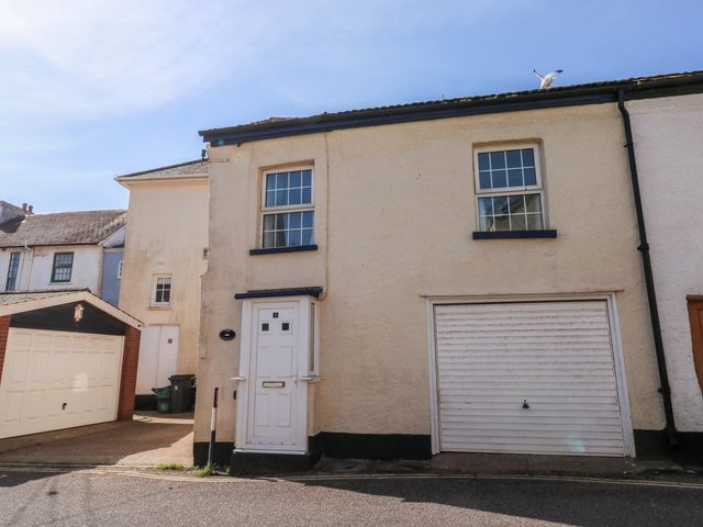 A house with a door and garage at The Cottage in Budleigh Salterton