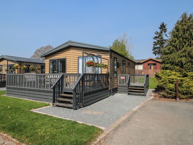 A house with a deck and planters at Tulip in Eardisland