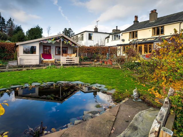 A garden with a pond and shed at Oakdene in Keswick