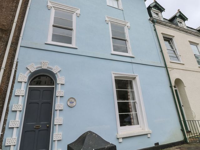 A blue building exterior with a door and windows at The English School, Flat 2 in Dartmouth