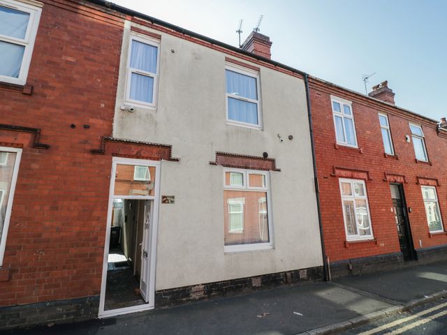 A building with white and red brick walls and windows at JMG House in West Bromwich