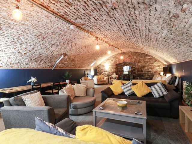 A living room with sofas and a dining area at 69 High Street Gatehouse Of Fleet