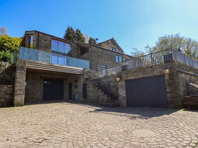 A house with a garage and balcony at Rocks Cottage Halifax
