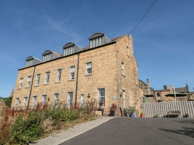 A building with windows and a pathway at Sunset Point in Alnwick
