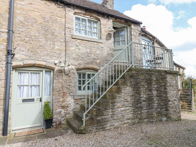 An entrance with stairs leading to a balcony at In & Out Cottage in Leyburn