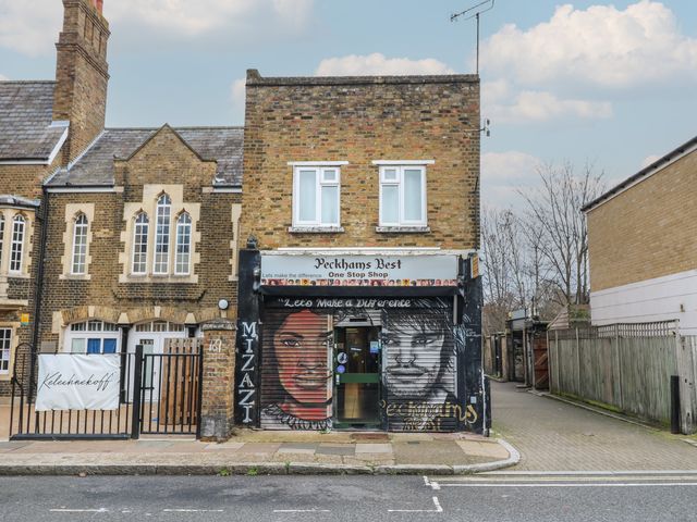 A storefront with murals at Peckhams Best in London