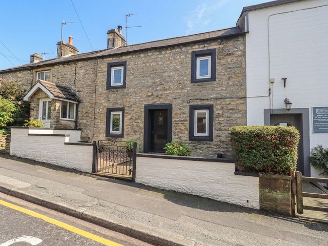 A stone cottage exterior with a garden at 4 Oak Cottages Bentham, Yorkshire