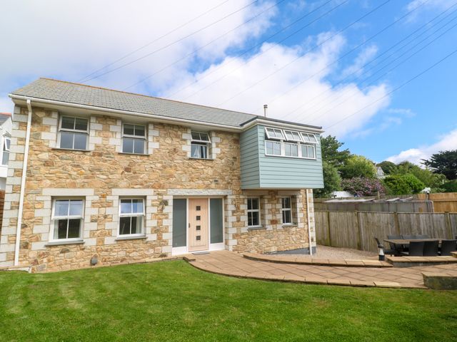 A house with windows and a patio at Rosevale Villa in St Ives