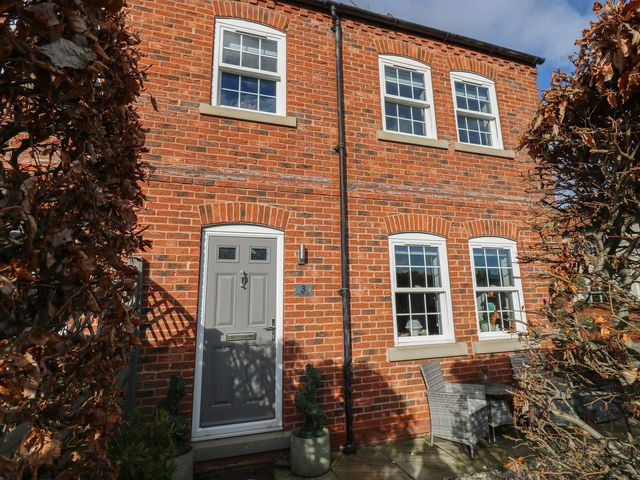 A house exterior with brick walls and a front door at Olive Tree Cottage, York