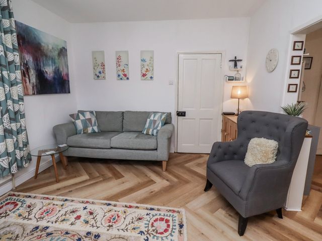 A living room with a sofa and armchair at 55 Meldon terrace Newbiggin-by-the-Sea