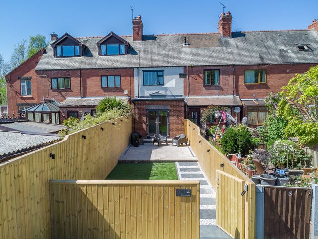 A garden with a pathway and seating area at 4 Bryn Heulog in Wrexham