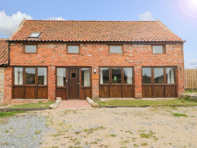 A brick house with multiple windows and a front door at Lavender Lodge in Hull