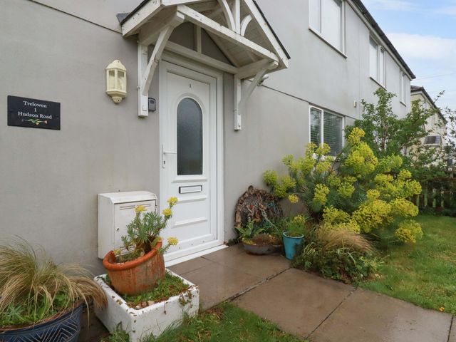 An entrance with a door and flower pots at Trelowen in Trenance