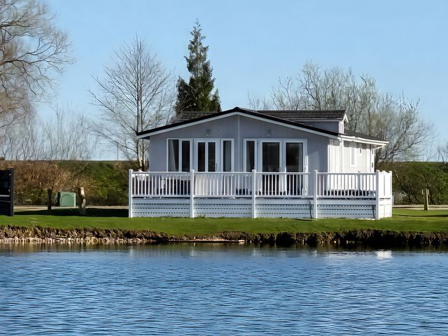 A house by a lake at Indulgence Fishing Lodge with Private Hot Tub in Tattershall