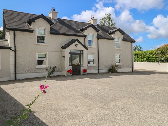 A house with a front door and flower pots at Greenfield House Aughavas, County Leitrim