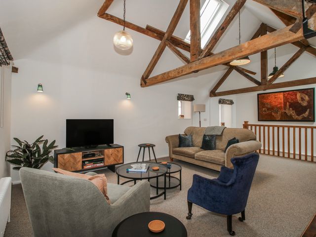 A living room with a television and sofa at The Old China Shop in Ludlow