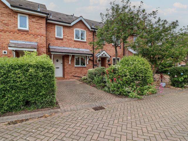 A house with bushes and trees in front at 10 Church Walks in Christleton