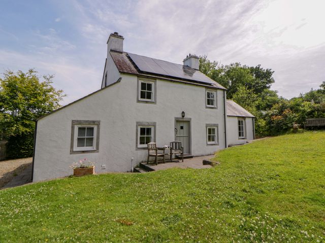 A house with solar panels and patio area at Cynefin in Newport, Pembrokeshire