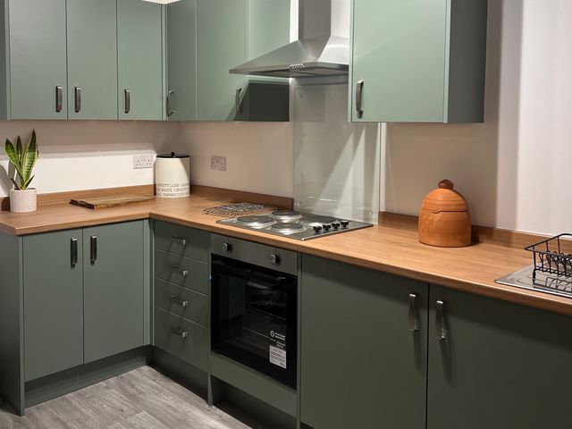 A kitchen with cabinets and stove at Little Marrakesh Lodge in Worcester
