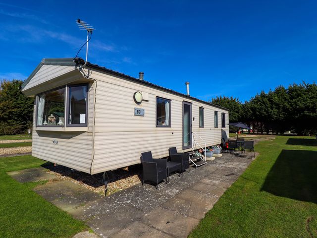 A caravan with outdoor seating at Southview Leisure Park - Firs 83 Skegness