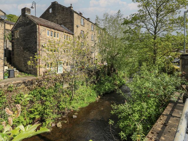 A view of buildings and stream at Riverview Cottage in Holmfirth