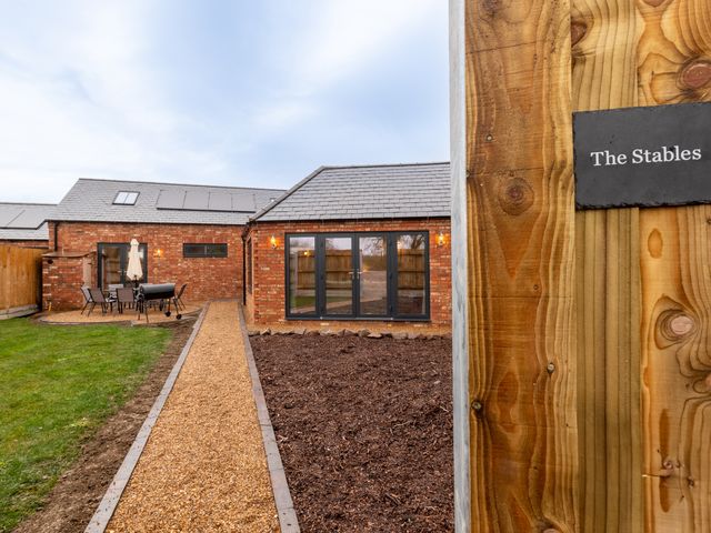 An outdoor area showcasing seating and a pathway at The Stables Catworth