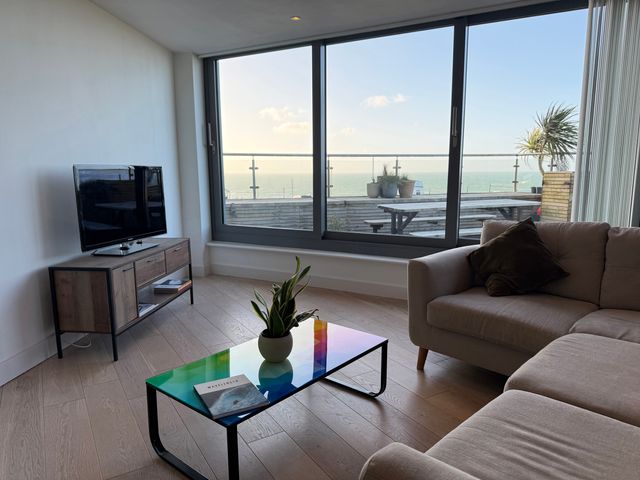 A living room with a television and coffee table at Apartment 29 in Newquay
