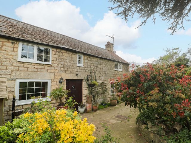 A cottage exterior with garden plants at The Annexe at Cherry Cottage Upton St Leonards