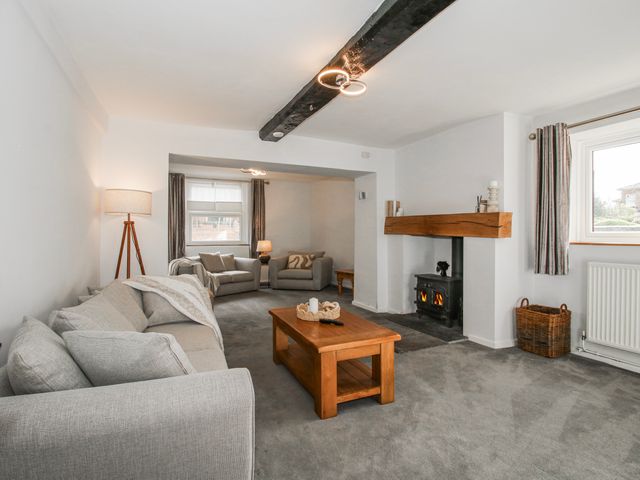 A living room with furniture and a fireplace at Corner House in Minsterley