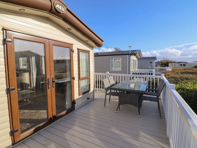 An outdoor area with a table and chairs at 23 Gull Court in Porthmadog