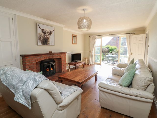 A living room with a fireplace and sofa at Highfields