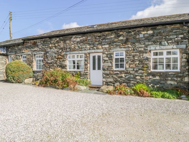 A stone building with windows and a front door at Cottage 2 in Keswick