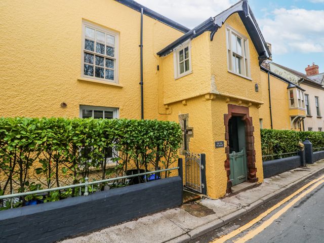 A house with a green door and windows at The Old Vicarage in Carmarthen