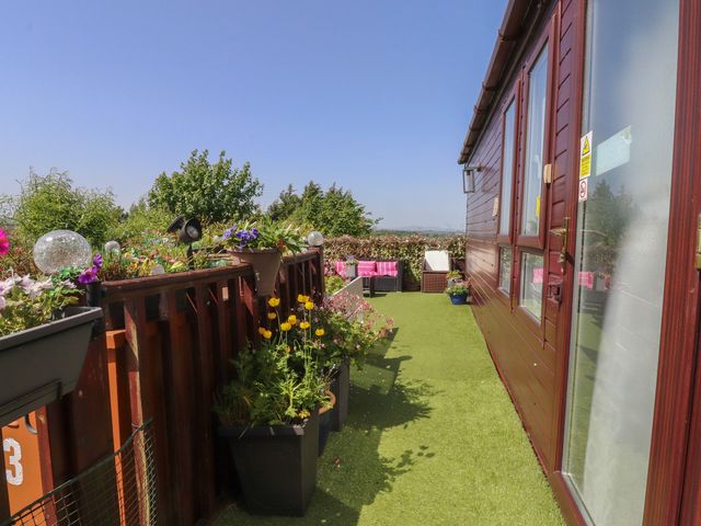 A garden with planters and artificial grass at 33 Pendle View in Clitheroe