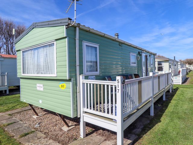 A caravan with a deck and windows at 517 - Promenade Caravan Site in Skegness