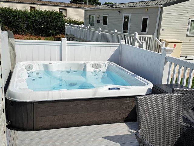A hot tub on a deck at Tranquil Lodge Retreat in Paignton
