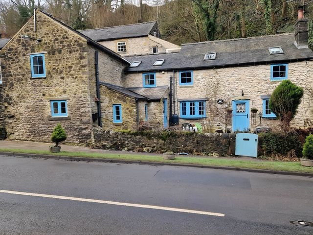 A stone cottage with blue windows and door at Rose Cottage - Cosy cottage in Millers Dale