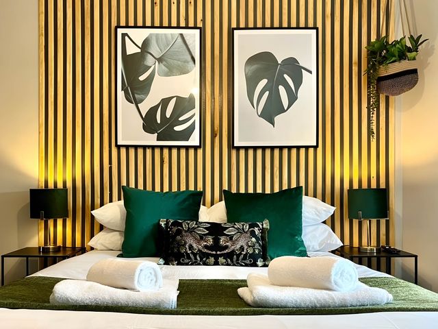 A bedroom with a bed and wall art at Central Ellesmere - Stay 2 - Parking - PetFriendly