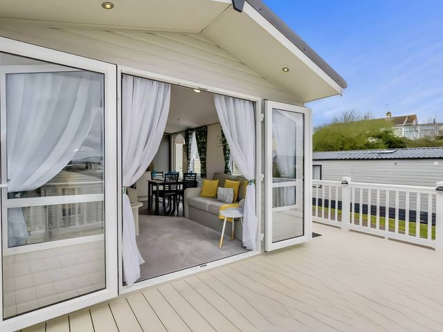 A living room area with sofa and dining table at Blue water 3 Beverley Bay Static Caravan in Paignton
