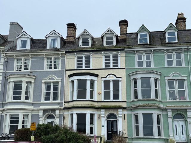 A row of houses with various colored facades at Sea View, East Parade Llandudno