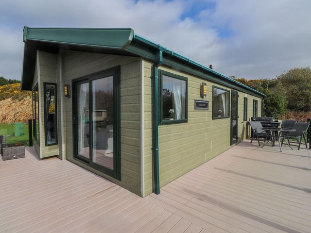 An outdoor area with seating and a modern cabin at 56 The Stables near Pwllheli