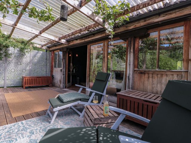 A deck with seating and table at Ferryman's Lodge in Brockweir