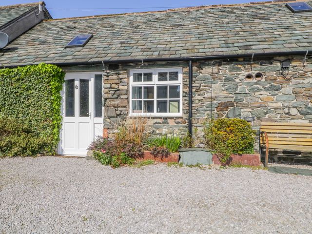 A stone front with a door and window at Mews Cottage 6 in Keswick