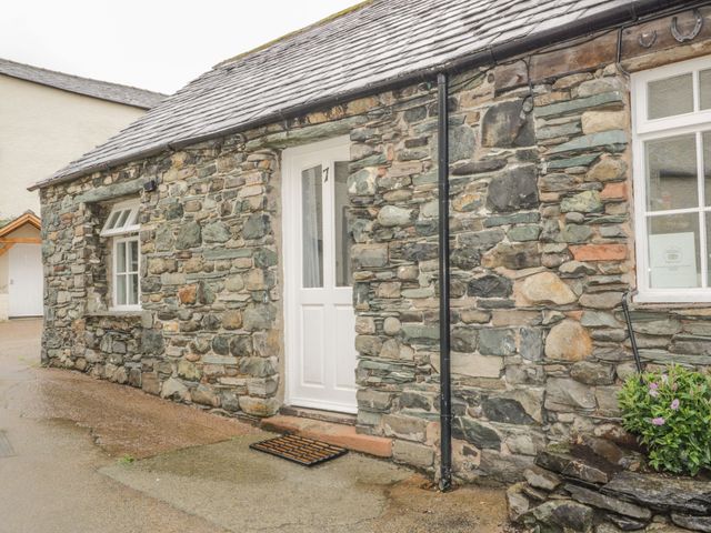 An exterior view of a stone cottage with a door and window at Mews Cottage 7 Braithwaite