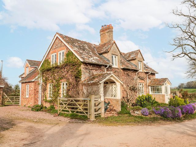 A house with a gate and flowers near the entrance at Tuxwell Lodge near Nether Stowey