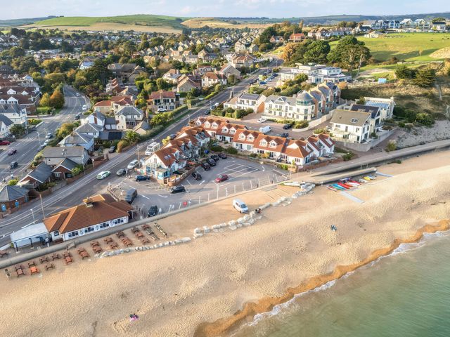 An aerial view of a beach and surrounding buildings at 32 Bowleaze Coveway in Preston