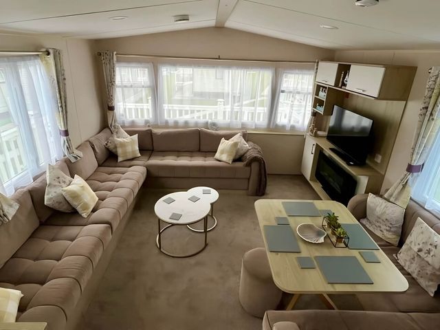 A living room with a sofa and coffee table at Static Caravan Hoburne Devon Bay in Paignton