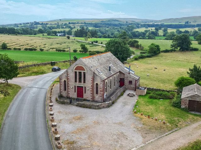 An exterior view of a building with surrounding landscape at Kaber Chapel in Kaber near Kirkby Stephen